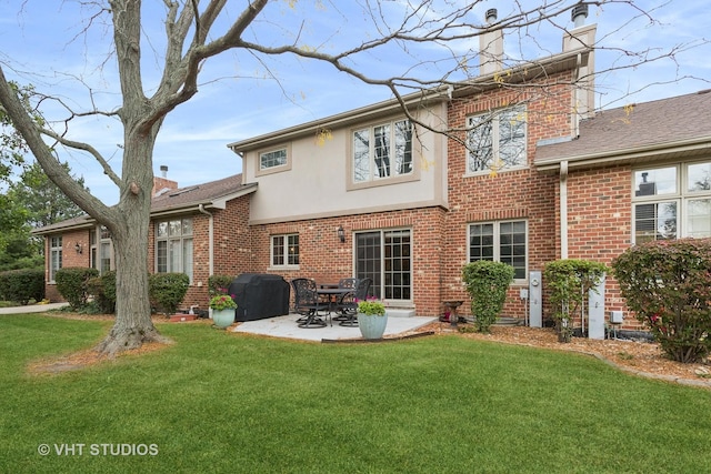 back of property featuring a lawn and a patio area