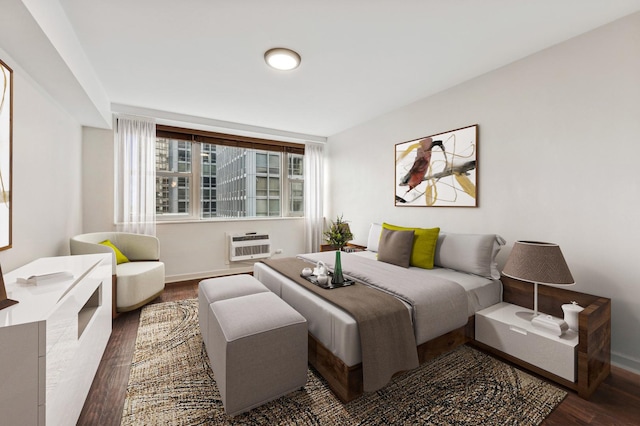 bedroom featuring a wall unit AC, baseboards, and dark wood finished floors