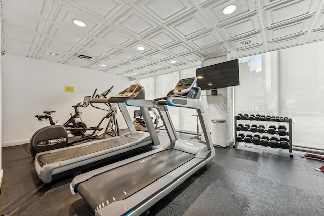 exercise room featuring an ornate ceiling, recessed lighting, and baseboards