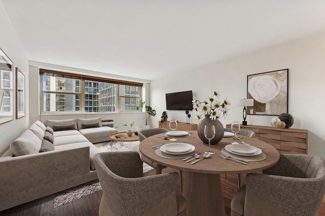 dining area featuring dark wood-type flooring