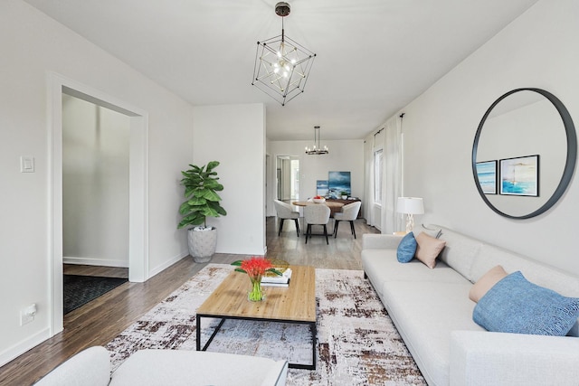 living room with hardwood / wood-style flooring and a notable chandelier