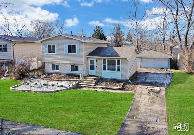 tri-level home with a garage, an outbuilding, and a front yard