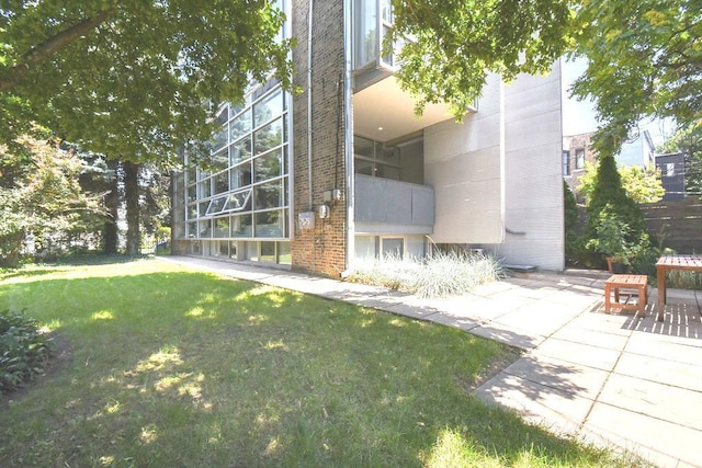 exterior space with a patio area and a yard