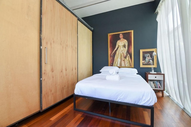 bedroom featuring dark hardwood / wood-style floors and a closet