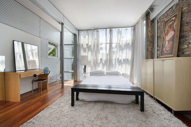 bedroom featuring dark hardwood / wood-style flooring and expansive windows