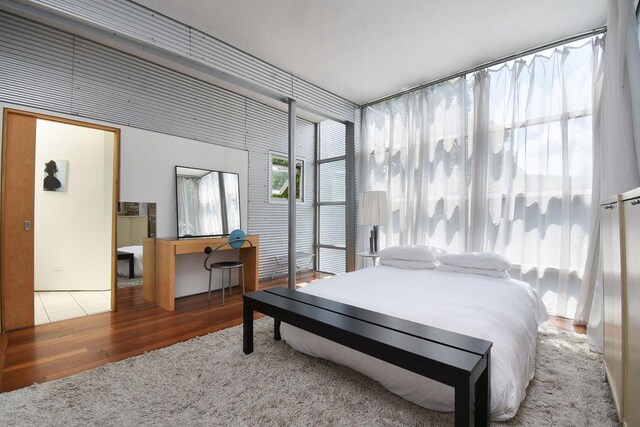 bedroom featuring wood-type flooring