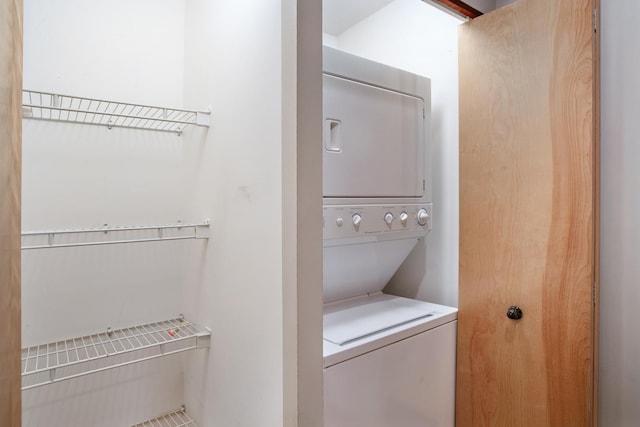 laundry area featuring stacked washer / drying machine