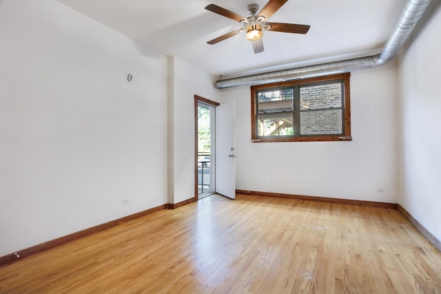 empty room with ceiling fan and light hardwood / wood-style floors