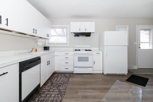 kitchen featuring plenty of natural light, sink, white cabinets, and white appliances