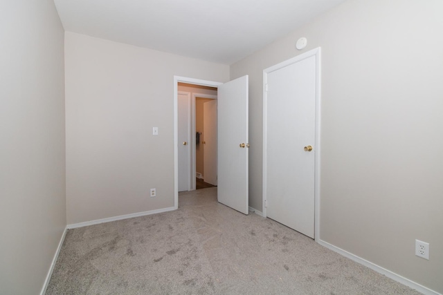 unfurnished bedroom featuring light colored carpet