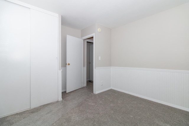 unfurnished bedroom with carpet and a closet