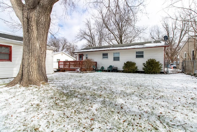 snow covered property featuring a wooden deck