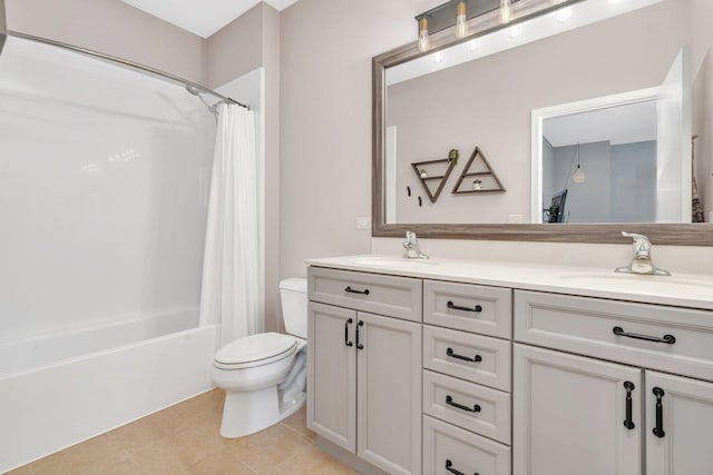 full bathroom featuring tile patterned flooring, vanity, shower / bath combo with shower curtain, and toilet