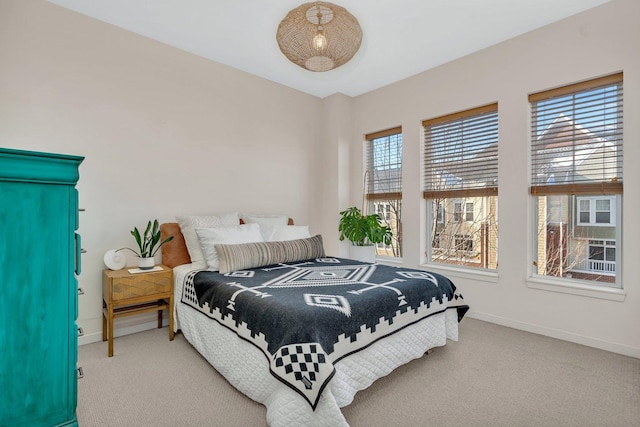 bedroom with multiple windows and carpet