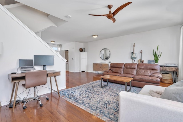 living room with ceiling fan and dark hardwood / wood-style flooring