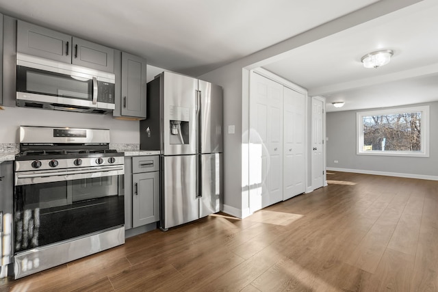 kitchen featuring dark hardwood / wood-style floors, gray cabinets, and appliances with stainless steel finishes