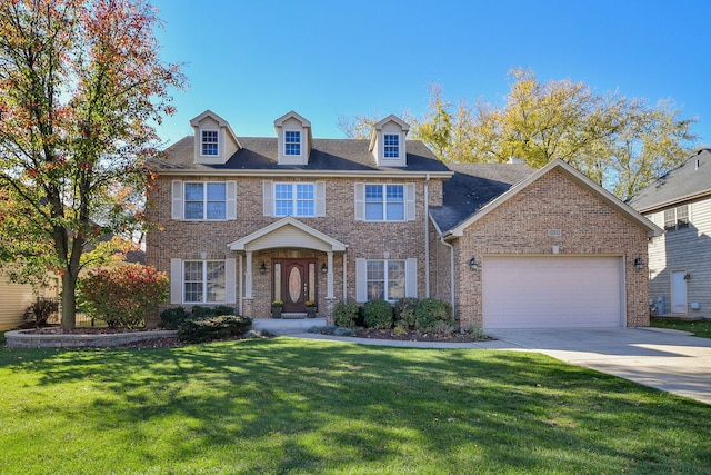 colonial home featuring a garage and a front lawn