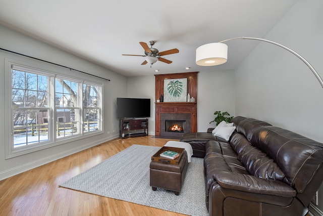 living room featuring ceiling fan and light hardwood / wood-style floors