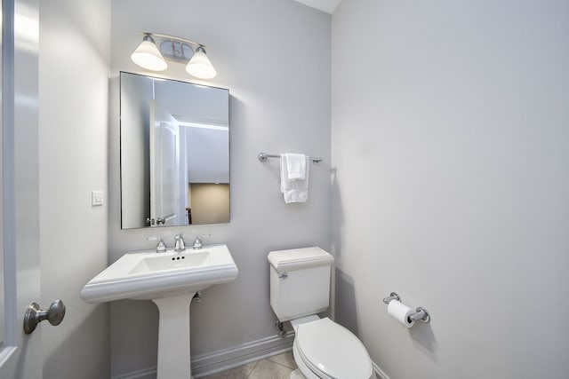 bathroom with toilet and tile patterned floors