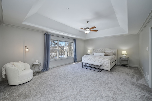 bedroom with ornamental molding, a raised ceiling, ceiling fan, and carpet flooring