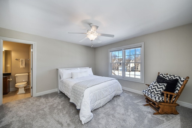 carpeted bedroom with ensuite bathroom and ceiling fan