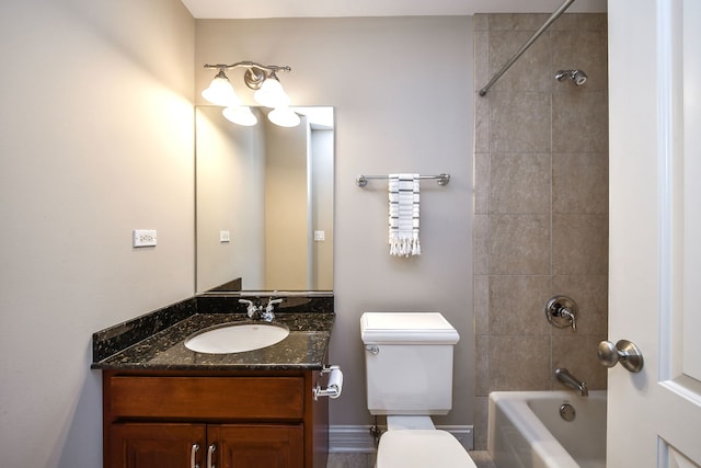 full bathroom with toilet, vanity, and tiled shower / bath