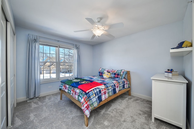 bedroom with ceiling fan, a closet, and carpet