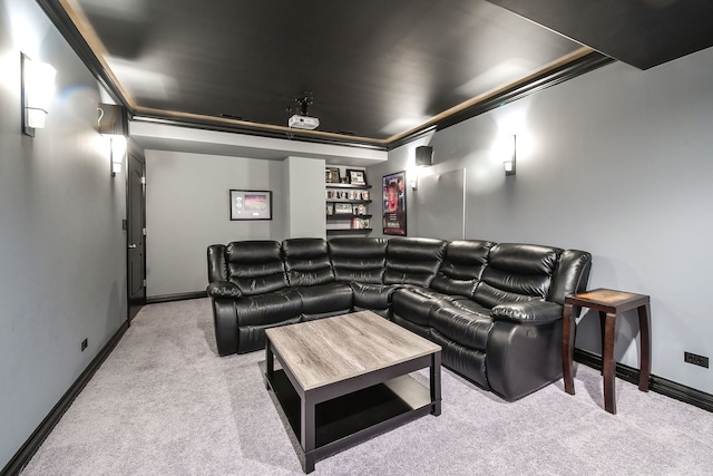 home theater room with light colored carpet and ornamental molding