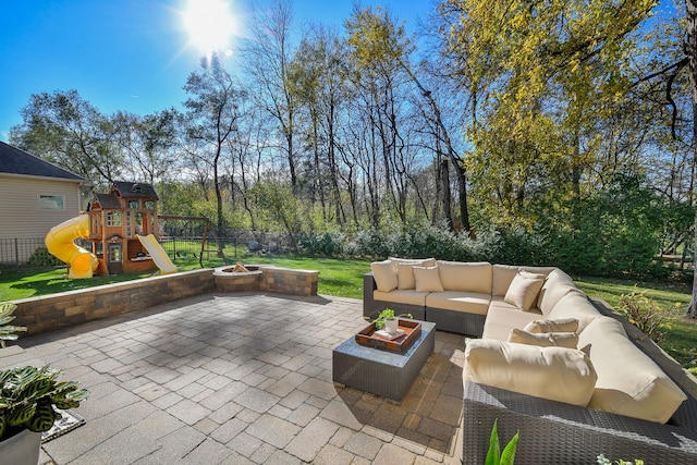 view of patio / terrace with a playground and an outdoor living space with a fire pit