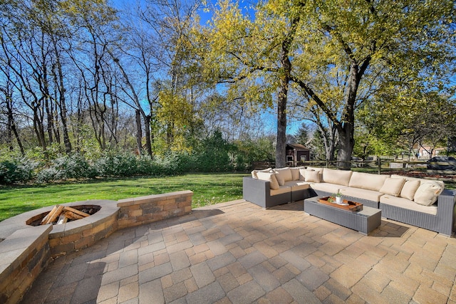 view of patio featuring an outdoor living space with a fire pit