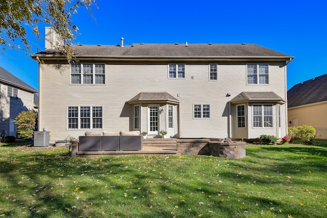 back of house with central AC unit, an outdoor hangout area, a patio area, and a lawn