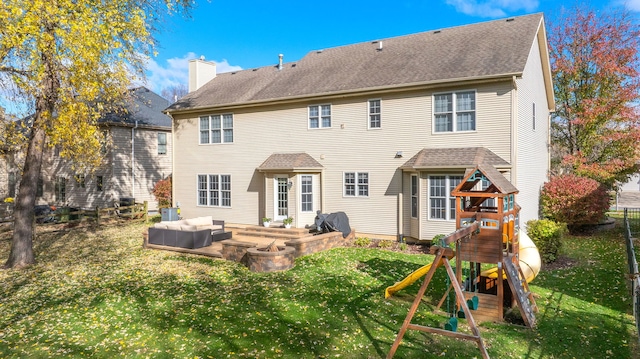 back of property with a yard, a playground, and an outdoor hangout area