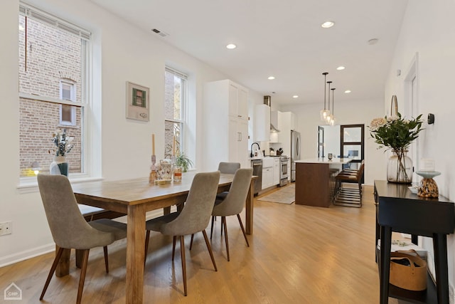 dining space with light hardwood / wood-style floors