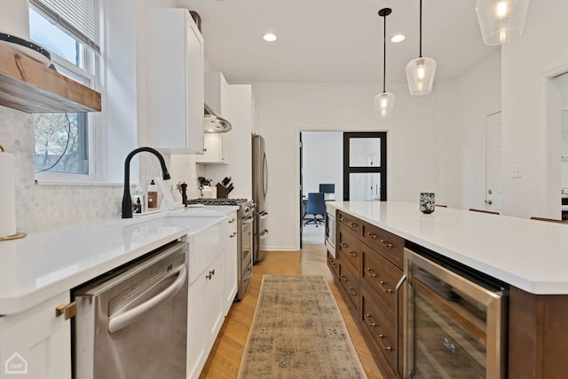 kitchen featuring wine cooler, white cabinetry, and stainless steel appliances