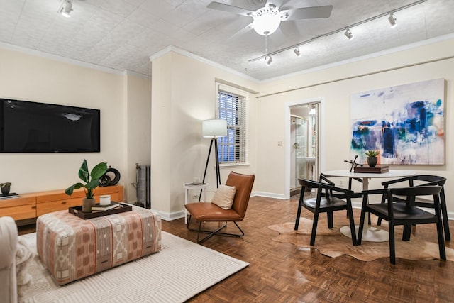 living room with rail lighting, parquet flooring, ceiling fan, and ornamental molding