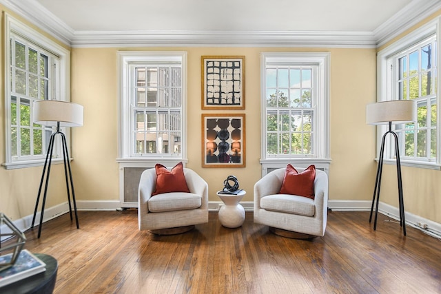 living area with dark wood-type flooring, crown molding, and a healthy amount of sunlight