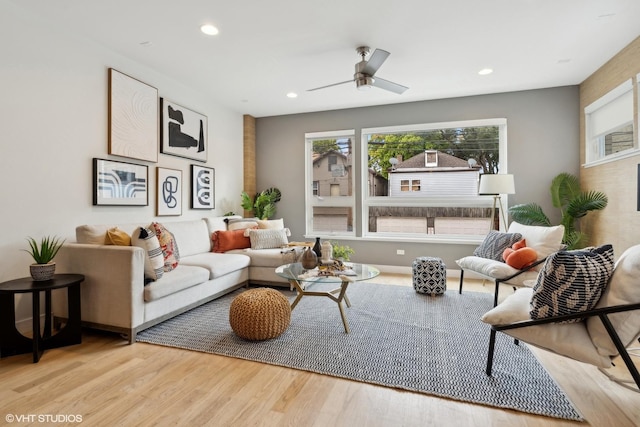 living room featuring ceiling fan and light hardwood / wood-style flooring