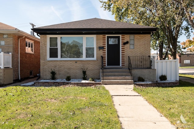 bungalow-style house with a front lawn