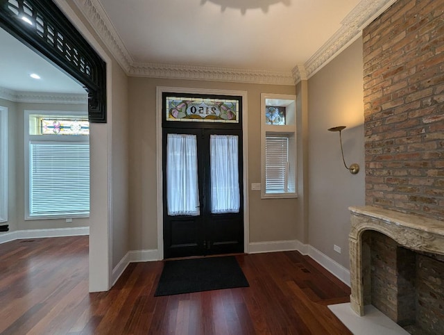 entryway featuring dark hardwood / wood-style floors, ornamental molding, and french doors