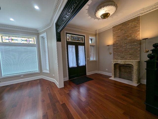 entryway featuring dark hardwood / wood-style floors, plenty of natural light, and crown molding