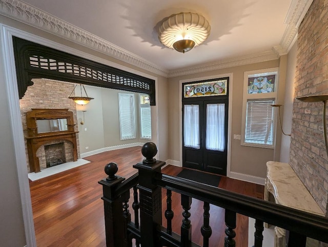 foyer featuring french doors, hardwood / wood-style flooring, and crown molding