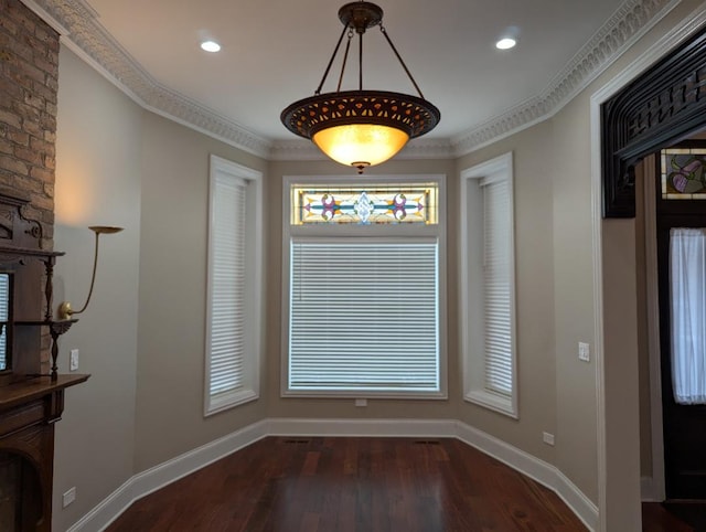 unfurnished dining area featuring dark hardwood / wood-style floors and ornamental molding