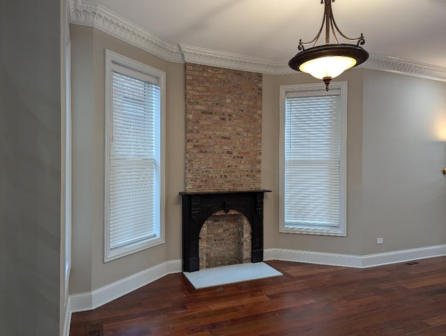 unfurnished living room with a fireplace, dark hardwood / wood-style floors, and crown molding