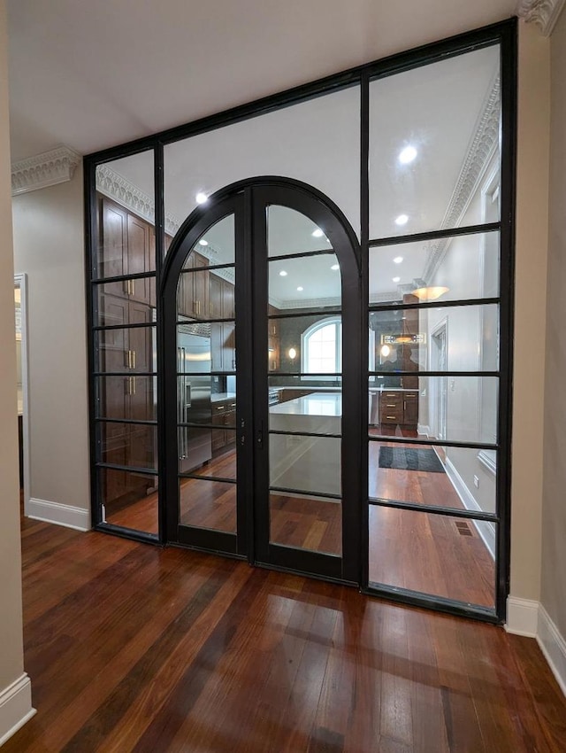 doorway to outside featuring french doors, hardwood / wood-style floors, and ornamental molding