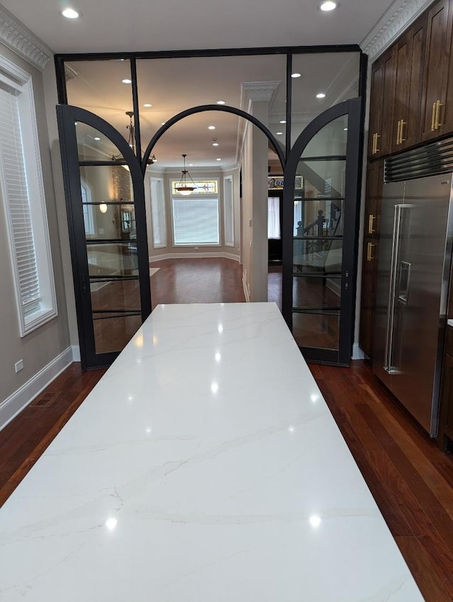 details with built in fridge and hardwood / wood-style flooring