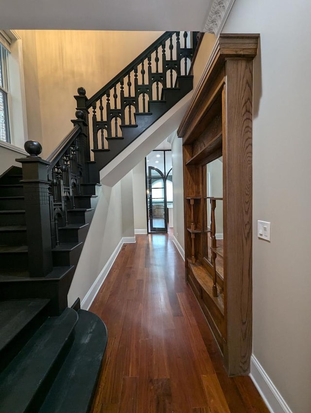 stairs featuring hardwood / wood-style flooring and plenty of natural light