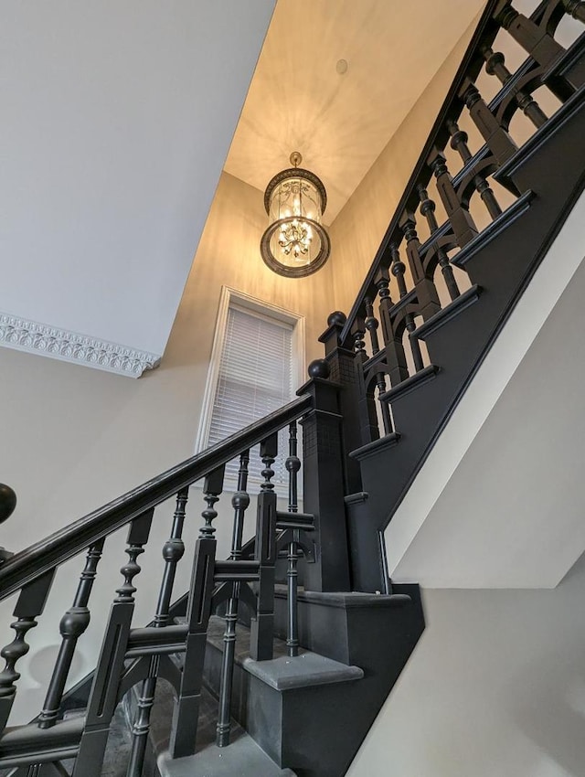 stairs with an inviting chandelier