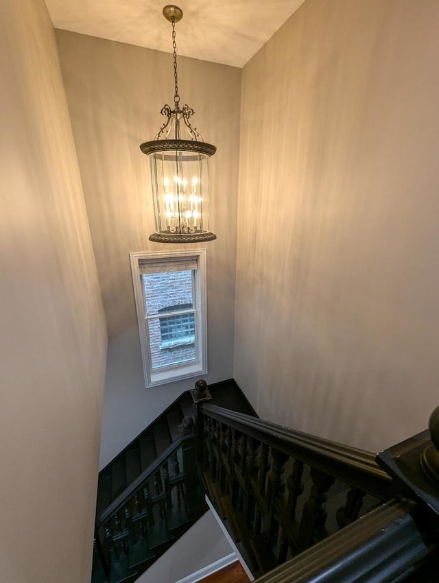 staircase featuring a chandelier