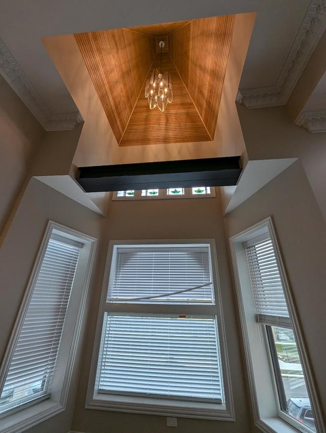 details with a notable chandelier and crown molding