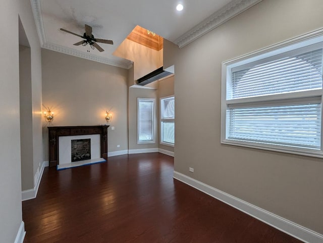 unfurnished living room featuring ceiling fan, dark hardwood / wood-style flooring, and crown molding